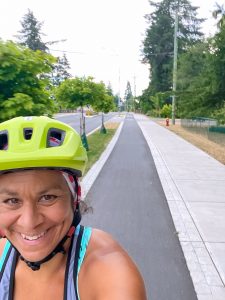 Helen smiling and enjoying cycling on a warm dry day.