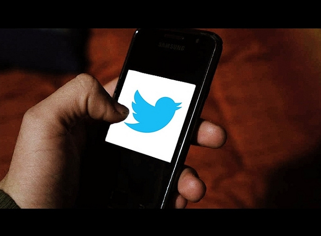 A mobile phone with the Twitter blue bird symbol